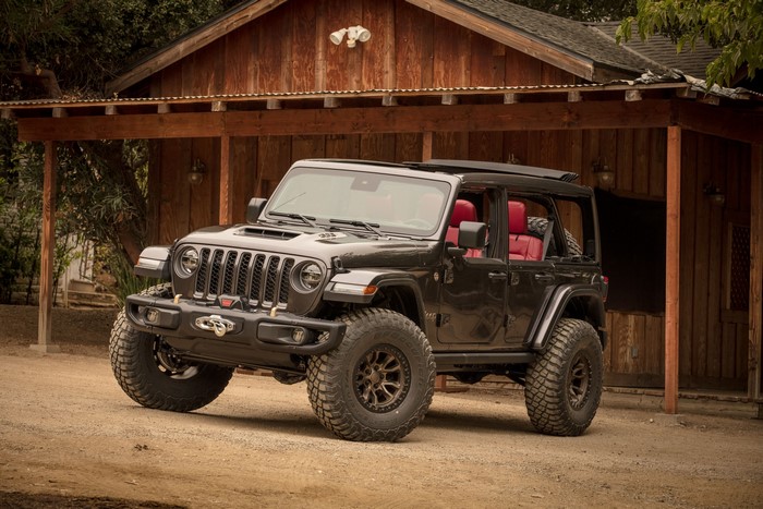 Black Jeep Wrangler Rubicon 392 parked near a wooden building