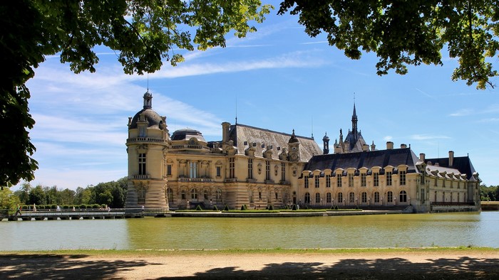 Chateau de Chantilly castle reflected in the water
