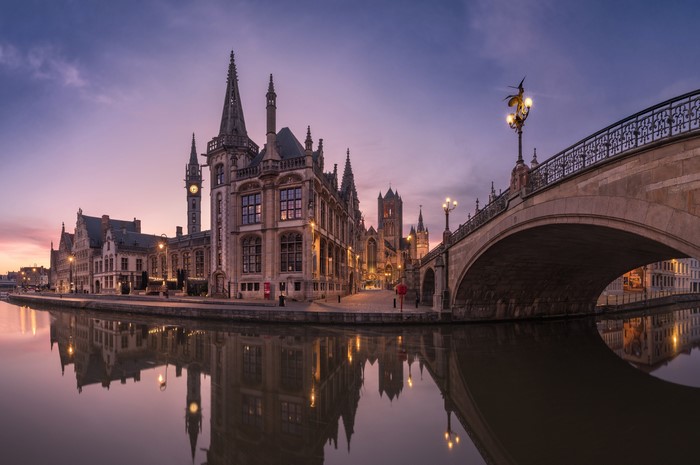 Ghent, Belgium at dusk with canal and bridge