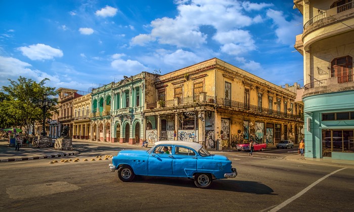 Blue classic car driving in Havana, Cuba