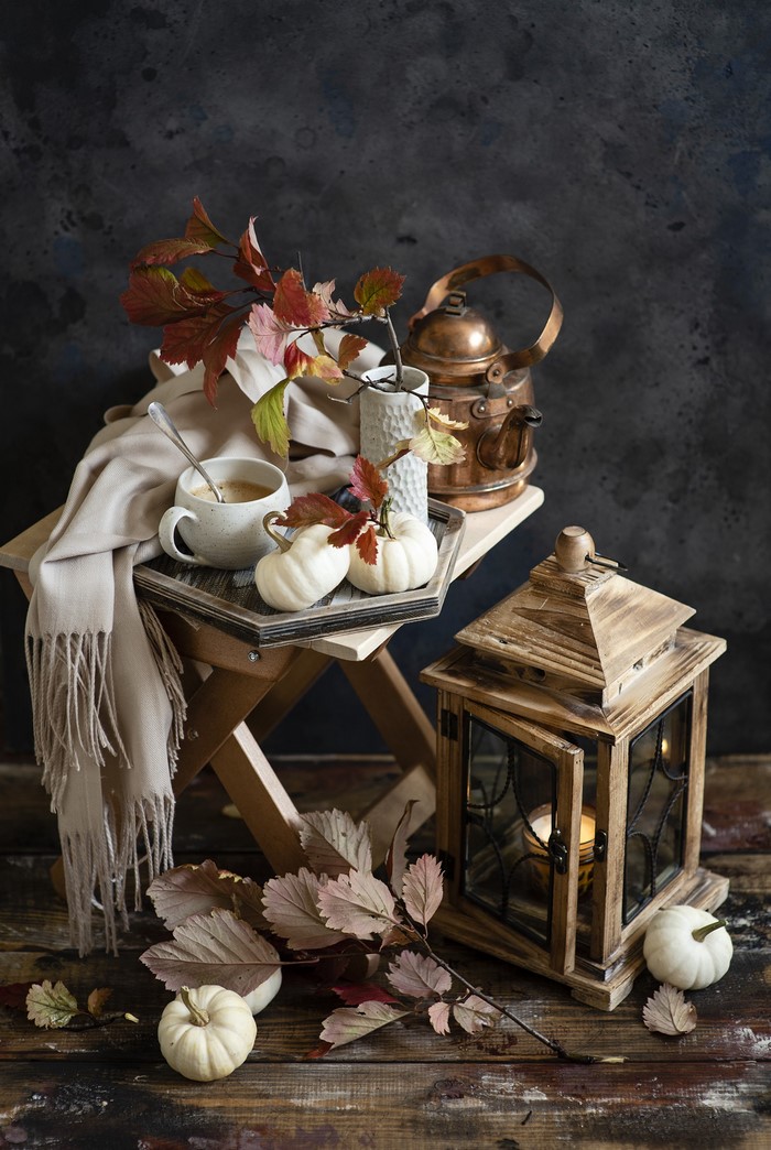 Autumn still life with pumpkins, kettle, and coffee