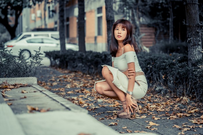 4K Asian Woman Sitting Among Autumn Foliage
