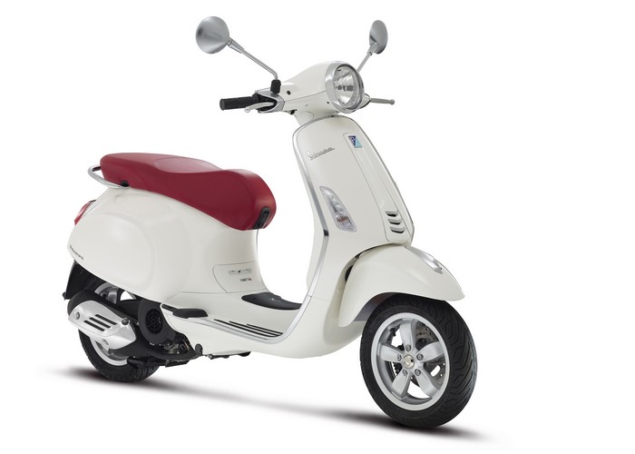White Vespa scooter with red seat