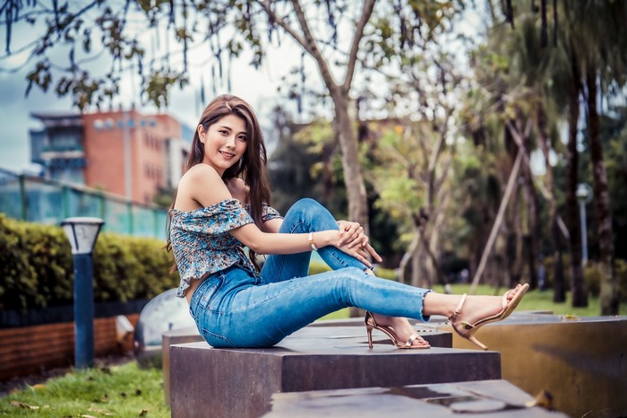 4K Asian Woman Sitting in Jeans and Blouse
