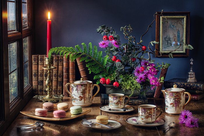 Still-life with tea set, macarons, and flowers