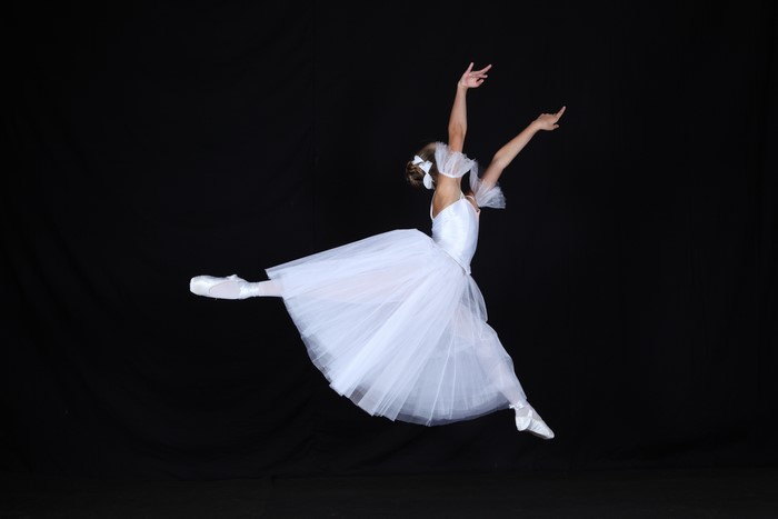 Ballet dancer in white tutu jumping