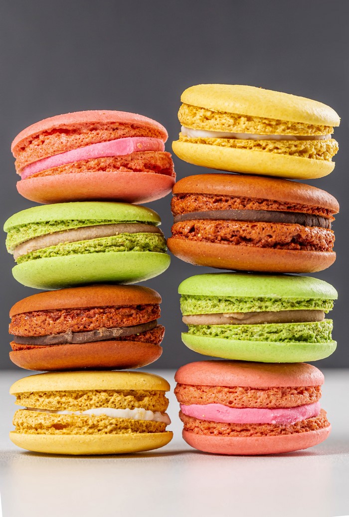 Stack of colorful macarons on a gray background