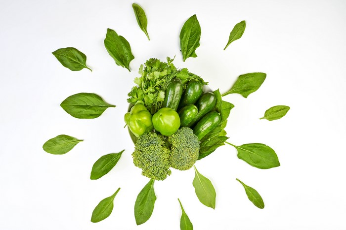 Green vegetables arranged on a white background