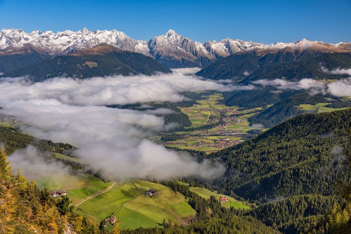 Alps Valley with Clouds and Snow-Capped Mountains