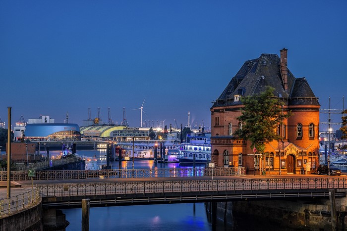 Hamburg harbor at dusk with buildings and boats