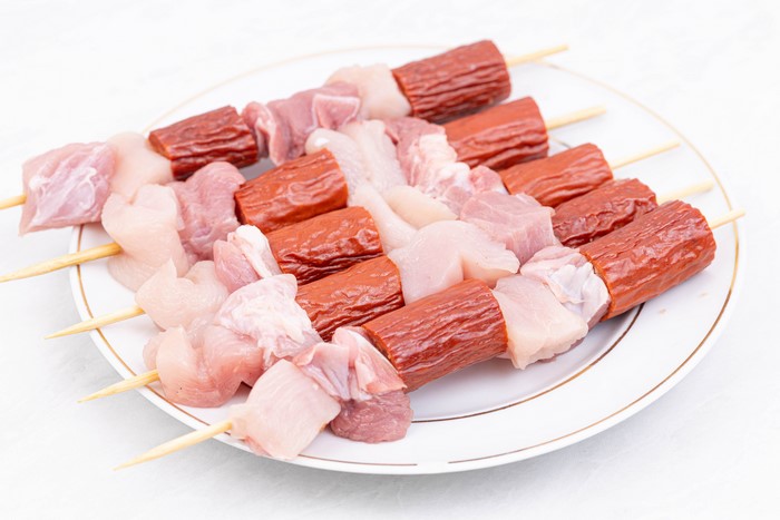 Shashlik with Vienna sausage and meat on a plate