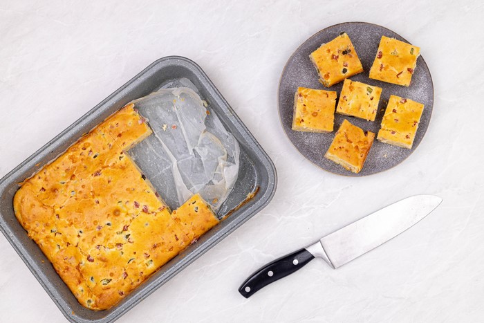 Baked pastry in a pan and on a plate with a knife