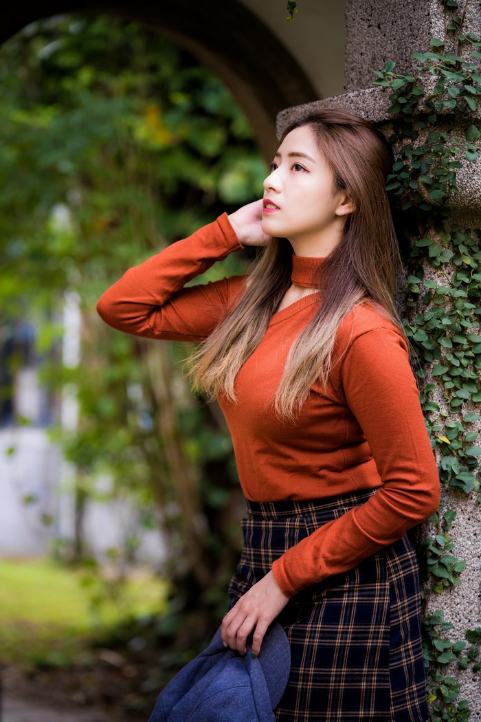 Asian woman with brown hair wearing a sweater