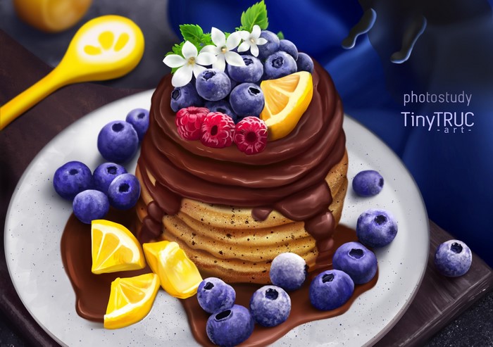 Pancakes with chocolate, blueberries, raspberries, and lemon slices