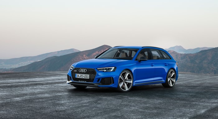 Blue Audi RS4 Avant on asphalt with mountains