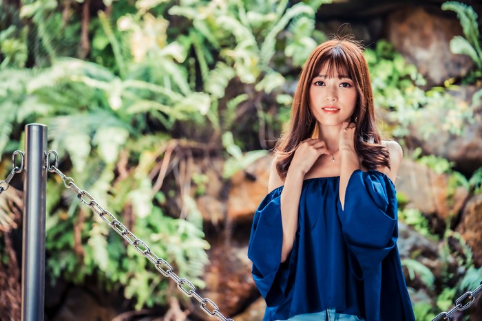 Asian woman with brown hair in a blue top