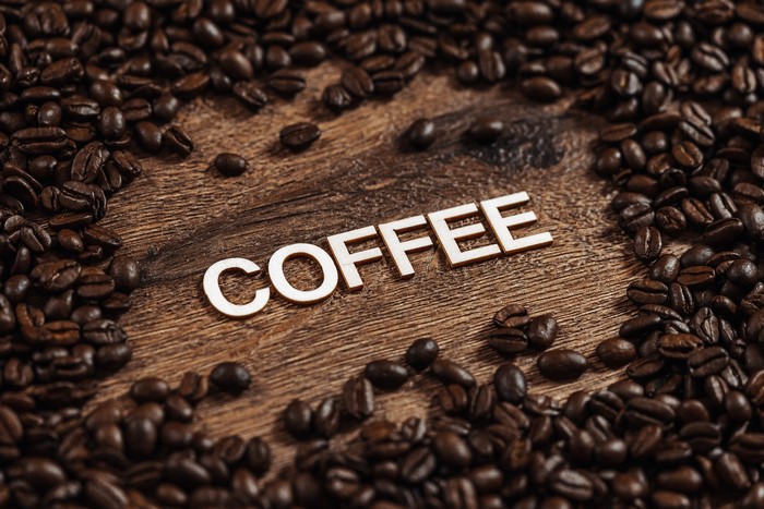 Coffee beans and the word COFFEE on wood