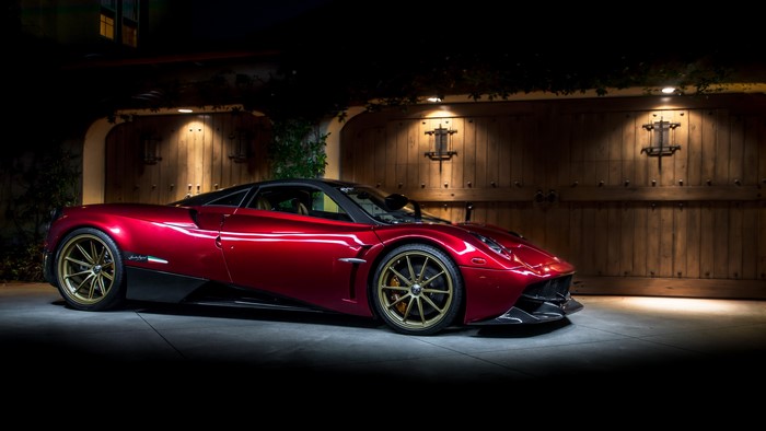 Red Pagani Huayra Senza Tempo parked in front of garage