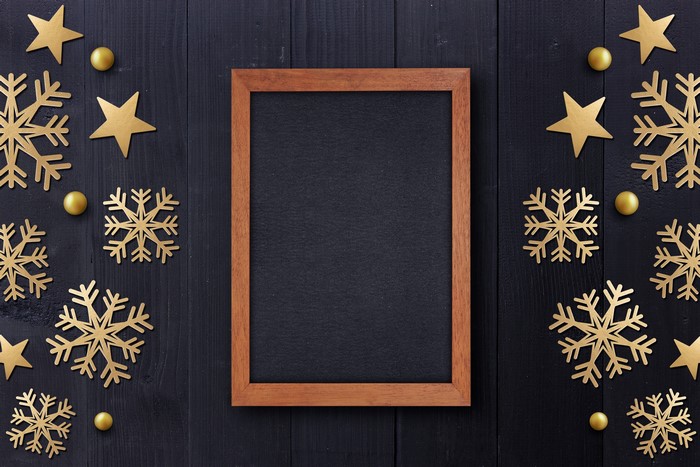 Christmas snowflakes and stars on a dark wooden background with a frame