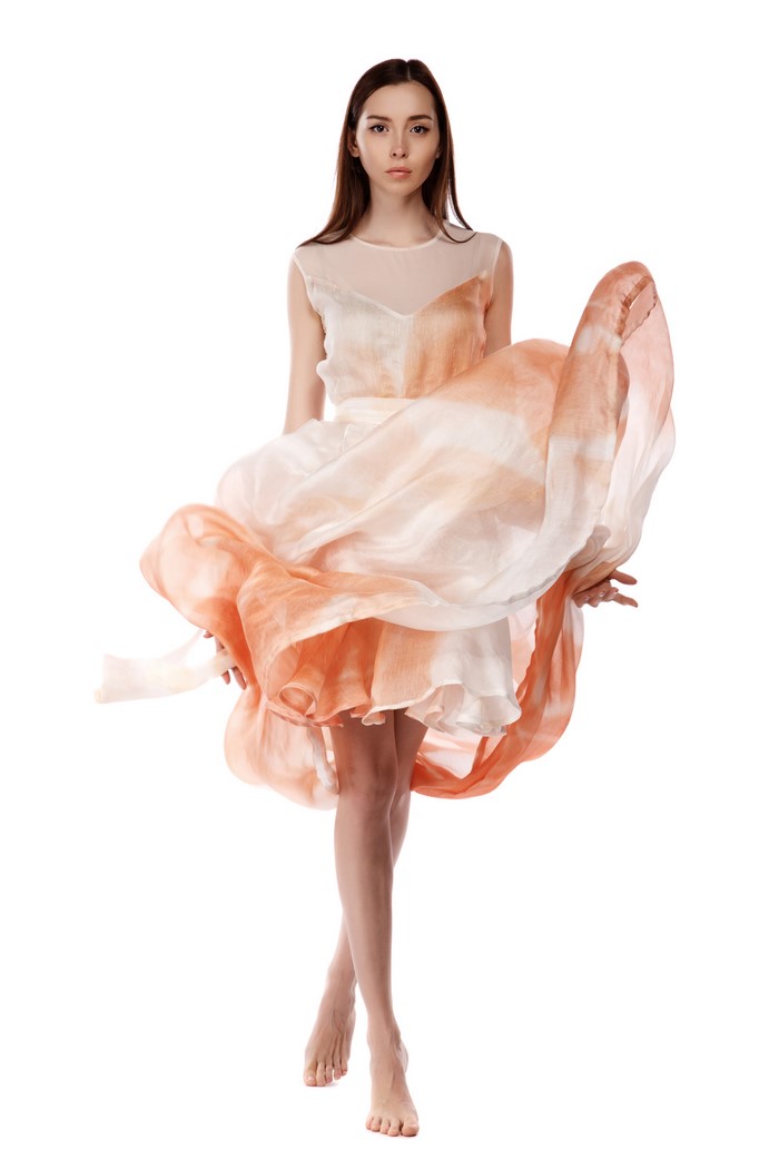 Model Maria in a flowing dress on white background