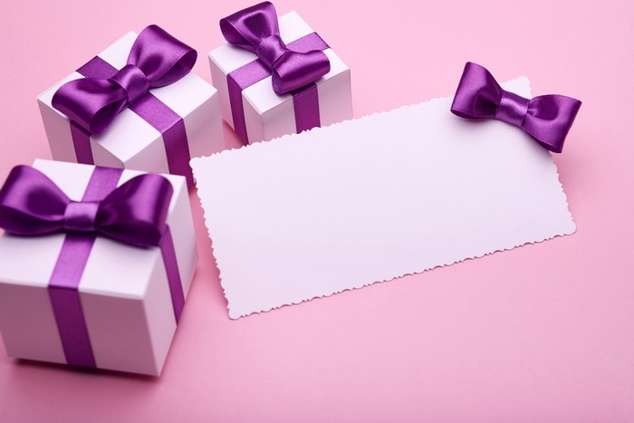 Gifts with purple ribbons and blank card