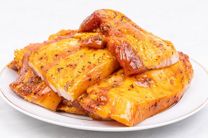 Marinated pork belly slices on a plate