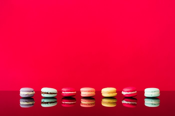 Macarons on a red background with reflection