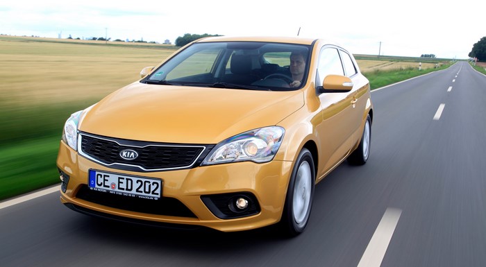Yellow 2011 Kia Pro Ceed Hatchback on Road