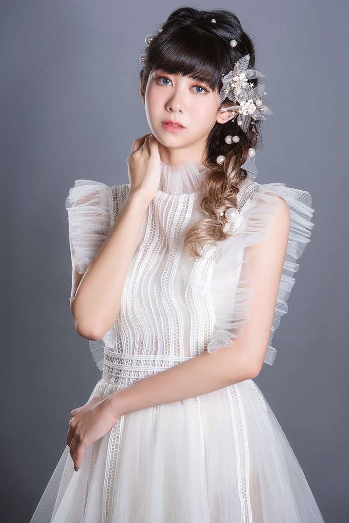 Asian Woman in Elegant White Dress Pose