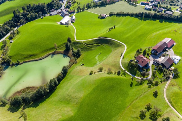 Aerial view of Kramsach, Austria with lake and farmhouses