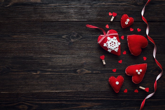 Valentine's Day hearts on dark wood planks