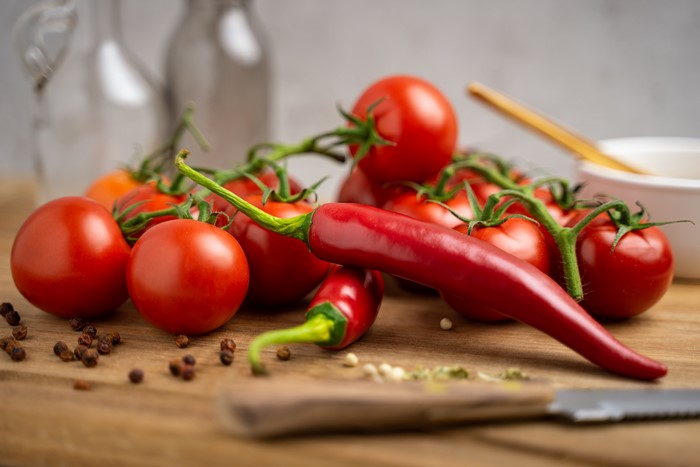 Tomatoes and Chili Peppers on a Wooden Board