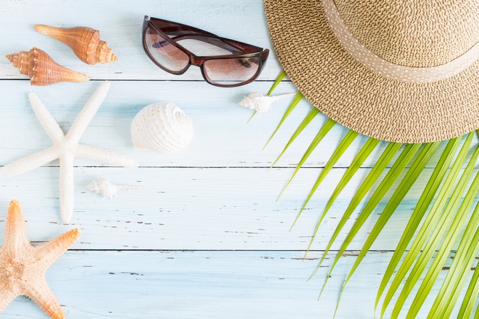 Summer beach accessories on a wooden background