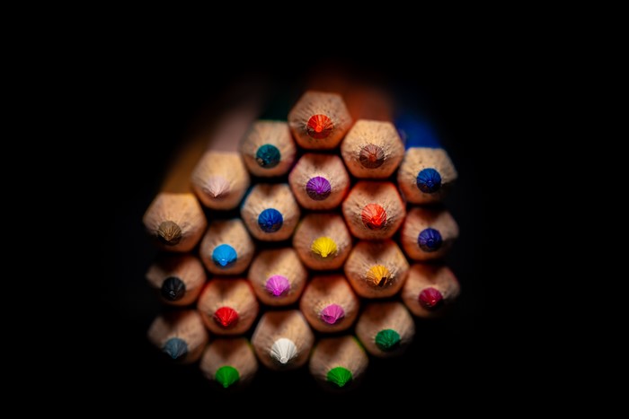 Many multicolor pencils closeup on black background