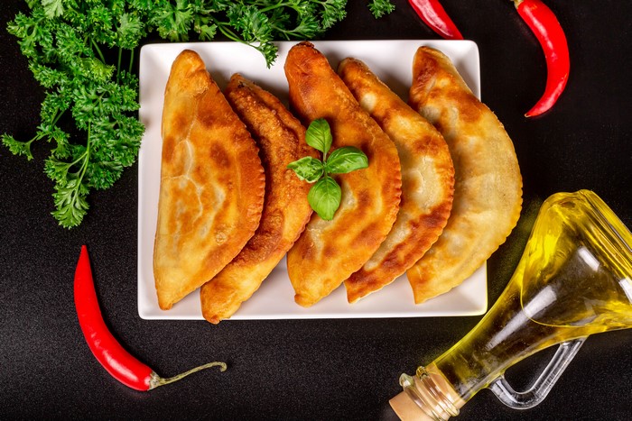 Chebureki with chili peppers and oil
