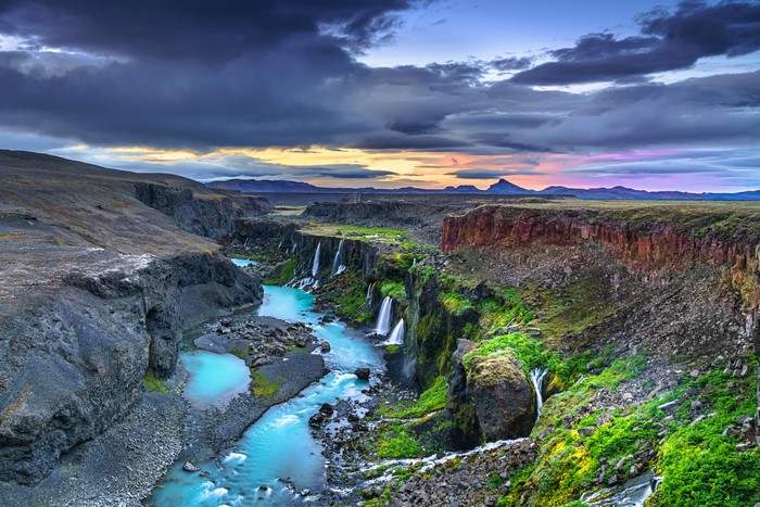 Canyon with waterfalls and dramatic clouds in Iceland