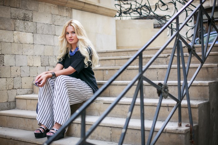 Blonde girl sitting on stairs