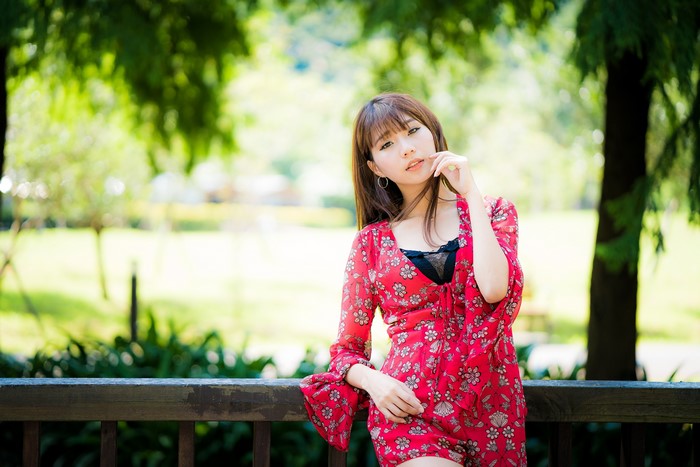 Asian woman in red floral dress outdoors