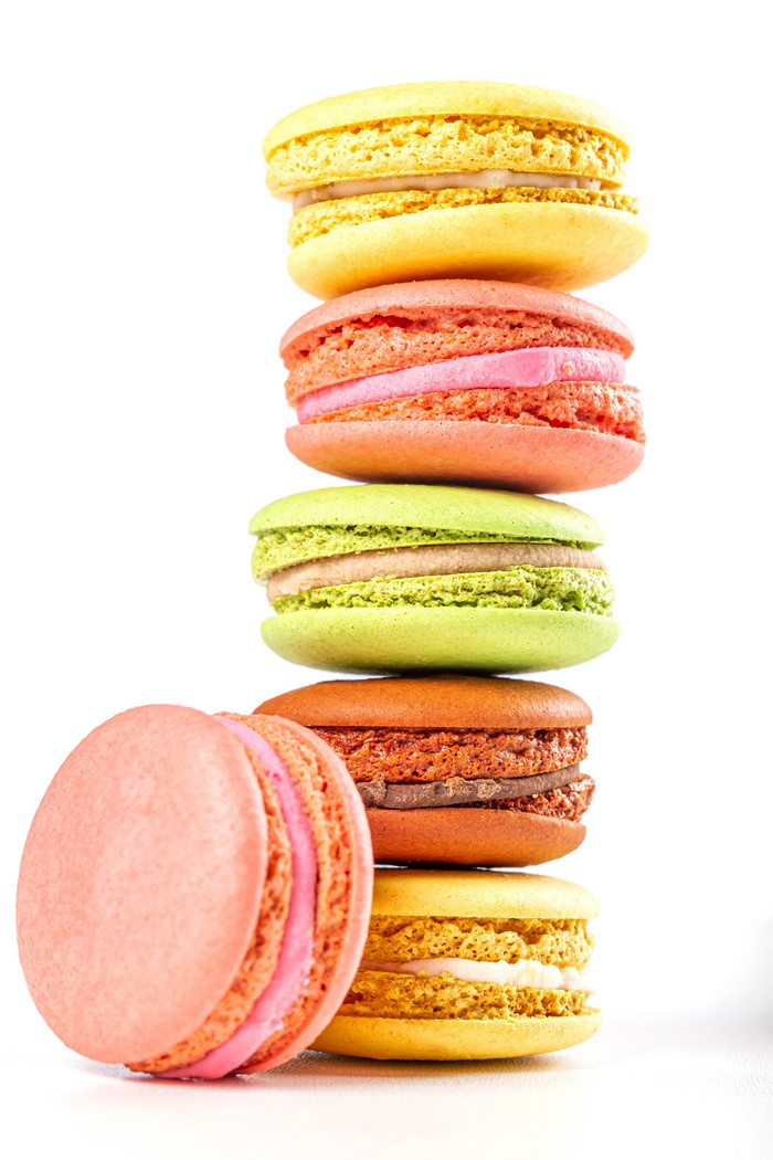 Stack of colorful macarons on a white background