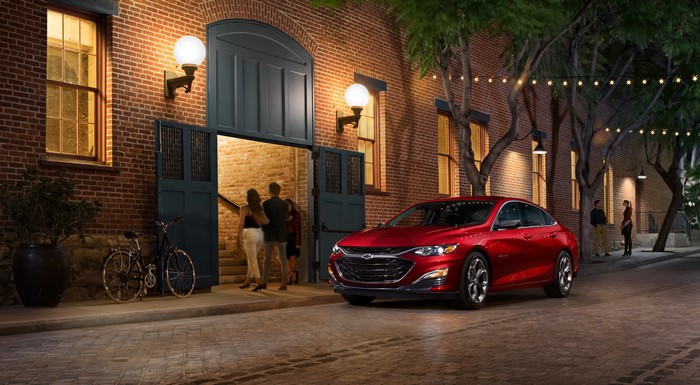 Red Chevrolet Malibu RS Sedan on a Brick Street at Night