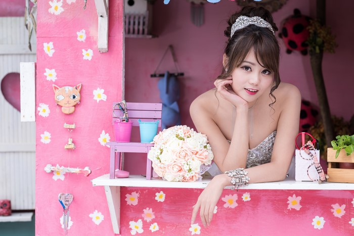 Asian woman in wedding dress with bouquet