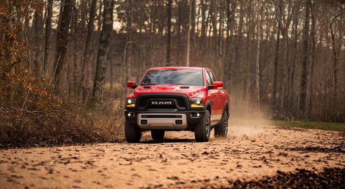 Red Ram 1500 Rebel Crew Cab driving on dirt road
