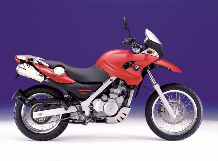 Red BMW F650GS motorcycle on a blue background