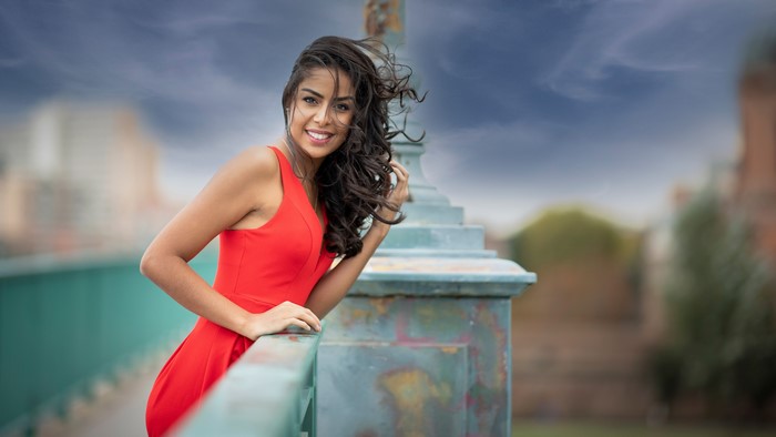 Woman in red dress on a bridge