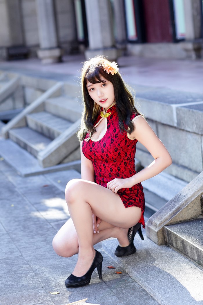 Asian Woman in Red Dress Sitting by Steps