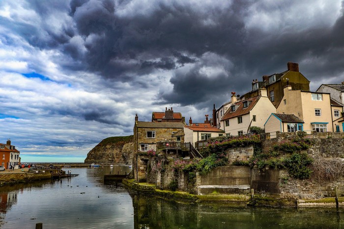 Village of Staithes, Yorkshire, England with dramatic clouds