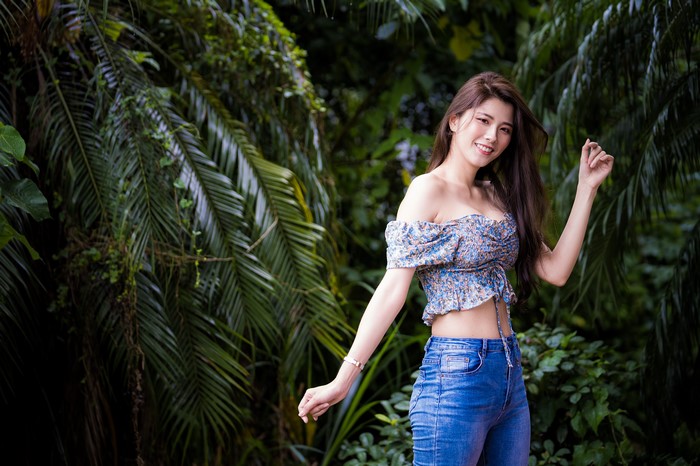 4K Asian Woman Smiling in Blue Jeans and Floral Blouse