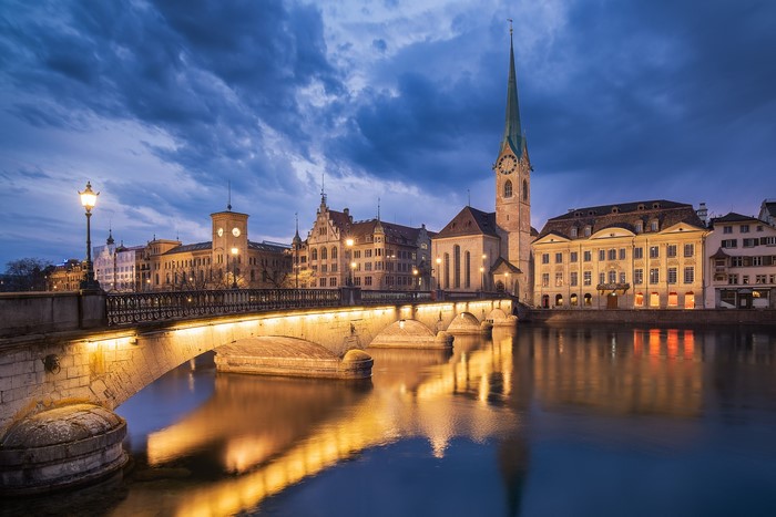 Zurich, Switzerland at dusk with a bridge and river