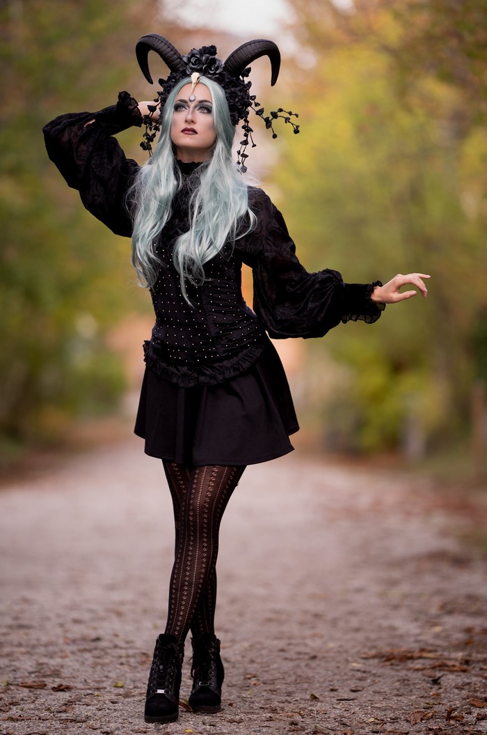 Woman in black gothic dress with horns