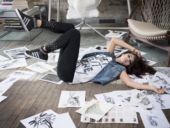 Selena Gomez lying on floor with drawings